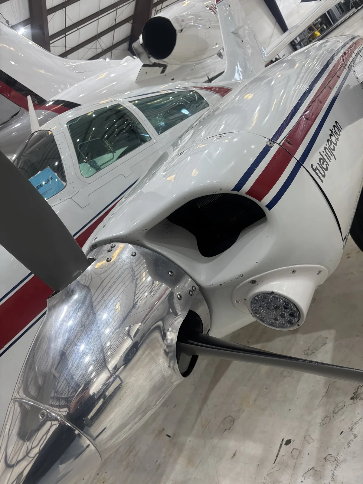 Close-up of a polished aircraft nose and propeller