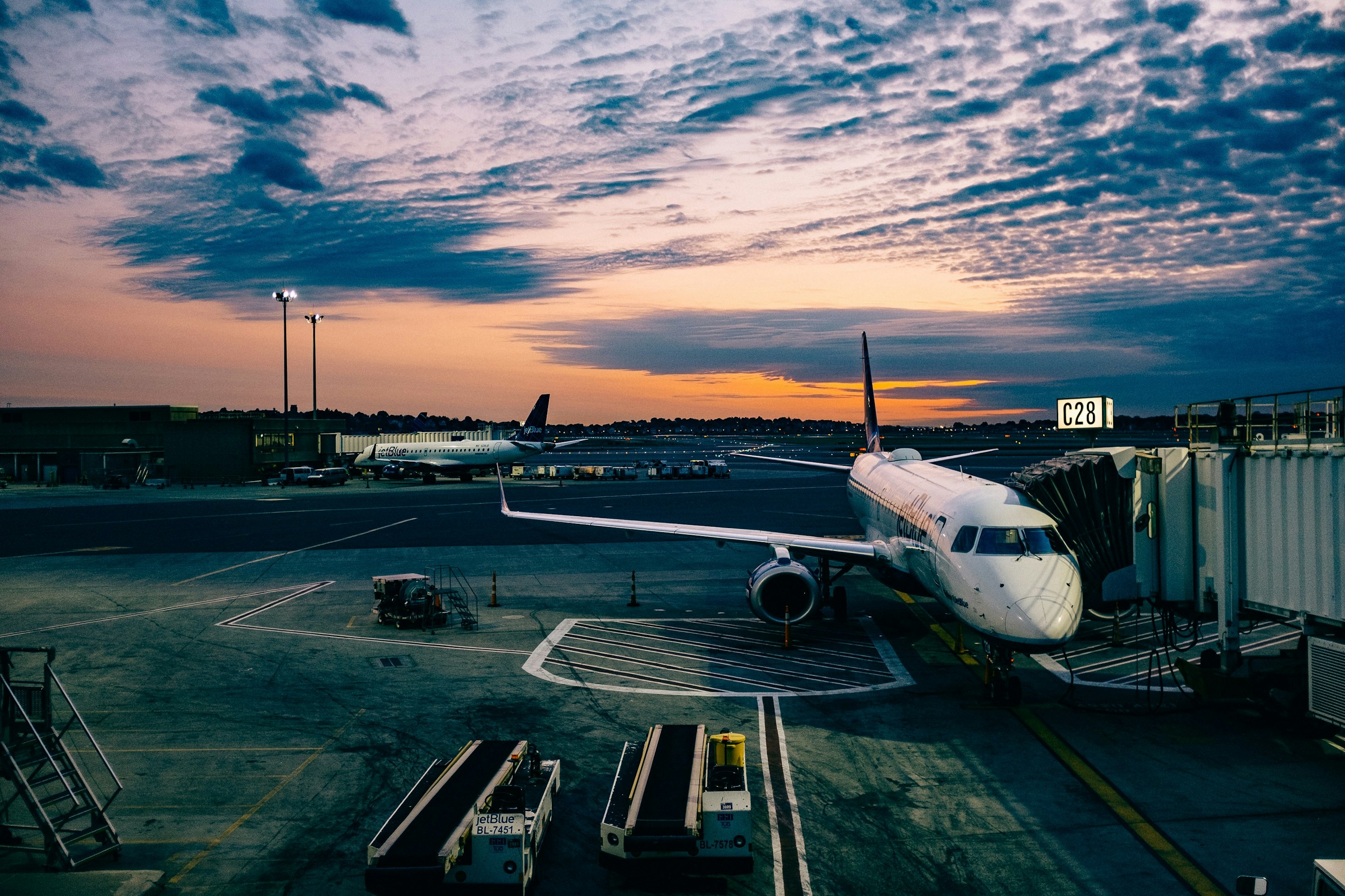 Aircraft on an airport apron at sunset